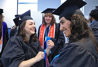 Jessica Lyons (left) adjusts the mortarboard worn by Jasmine Zandi before the University of Arkansas Clinton School of Public Service commencement ceremony at the Ron Robinson Theater in downtown Little Rock on Saturday, May 4, 2024. (Arkansas Democrat-Gazette/Colin Murphey)